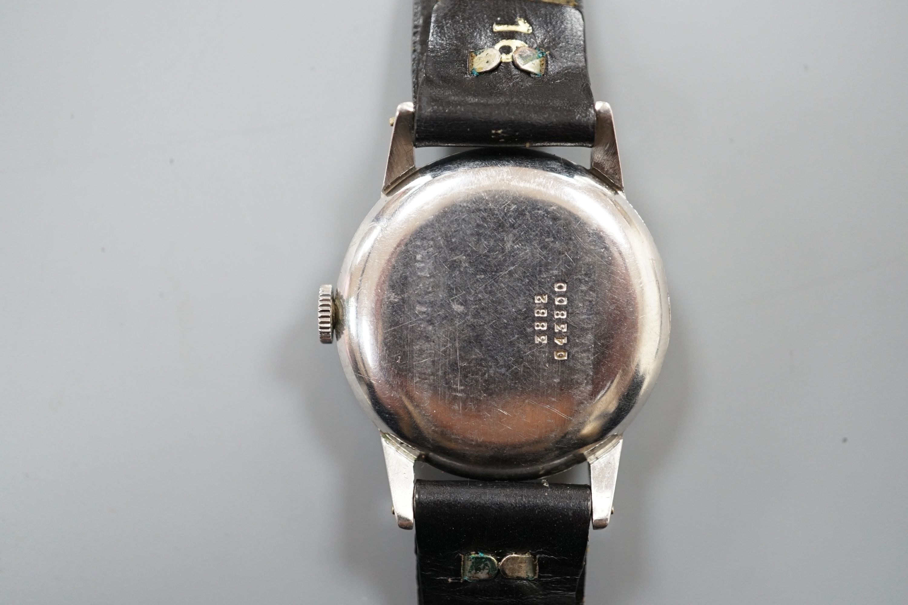 A gentleman's stainless steel manual wind wrist watch, the case and movement signed Rolex, on associated leather strap, the case back numbered 3882 over 043800.